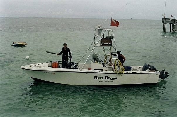 Craig Quirolo aboard a Reef Relief outboard installing demarcation buoys.